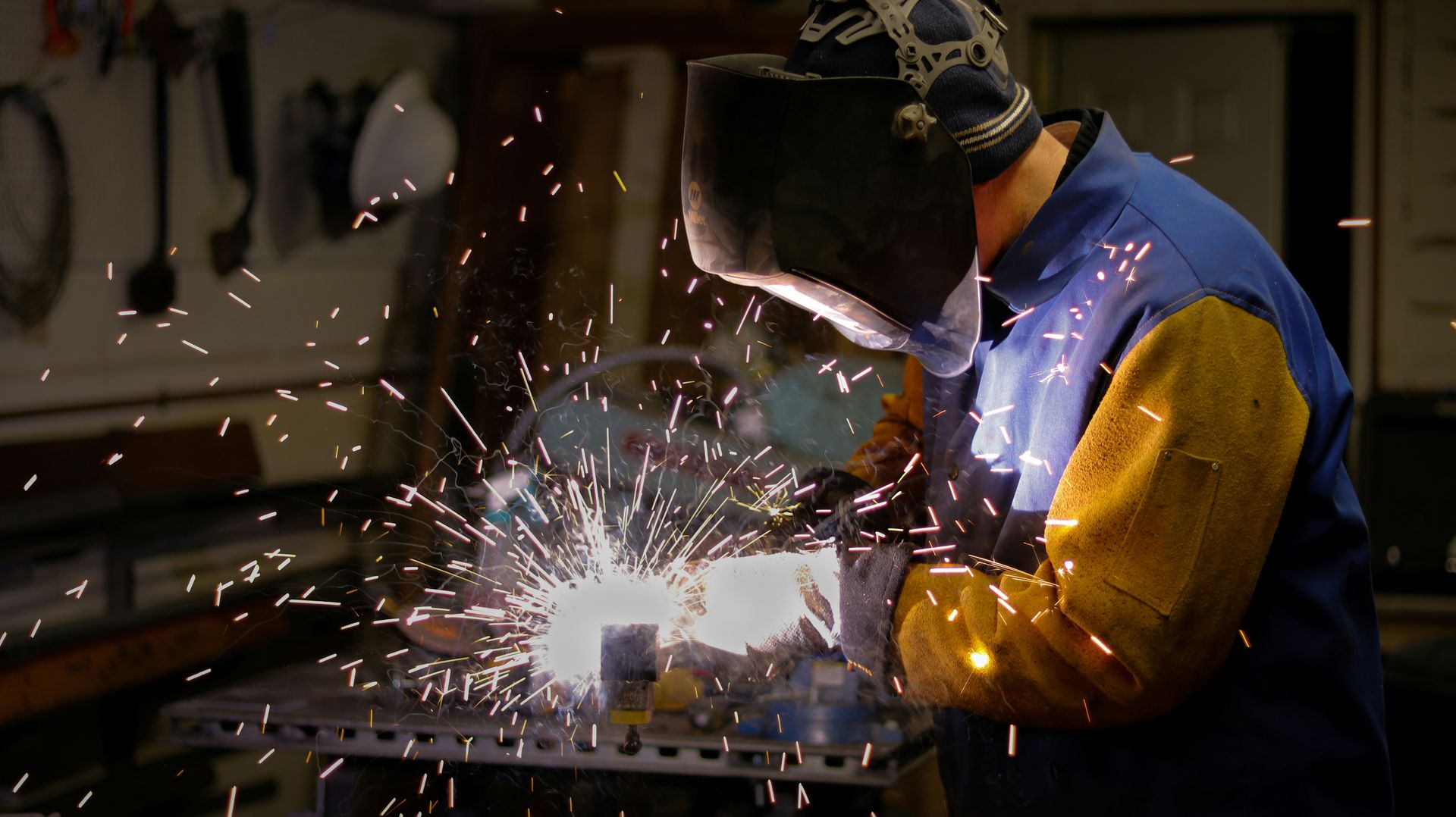 a man wearing a blue protective gear working on a machine